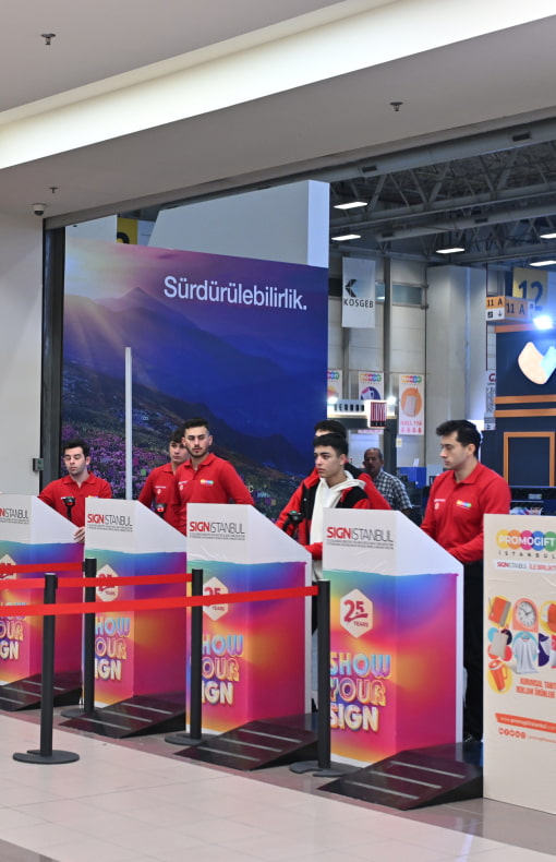 Exhibition entrance area with Bilsan Flag banner and staff ready to welcome visitors