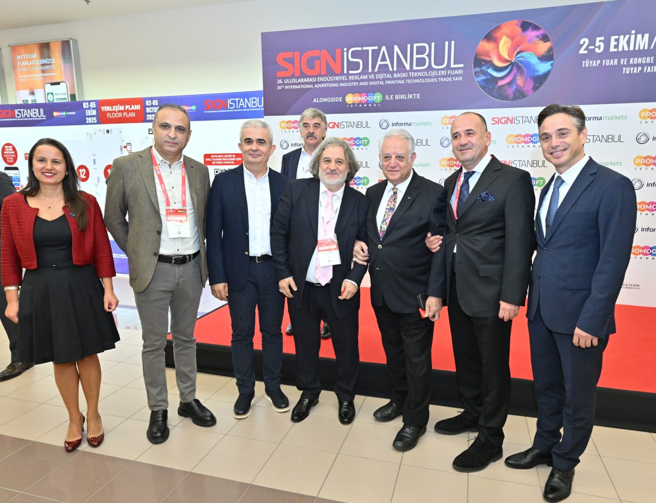 A group of musicians in red uniforms playing instruments like drums, trumpet, and saxophone at SIGN İstanbul entrance