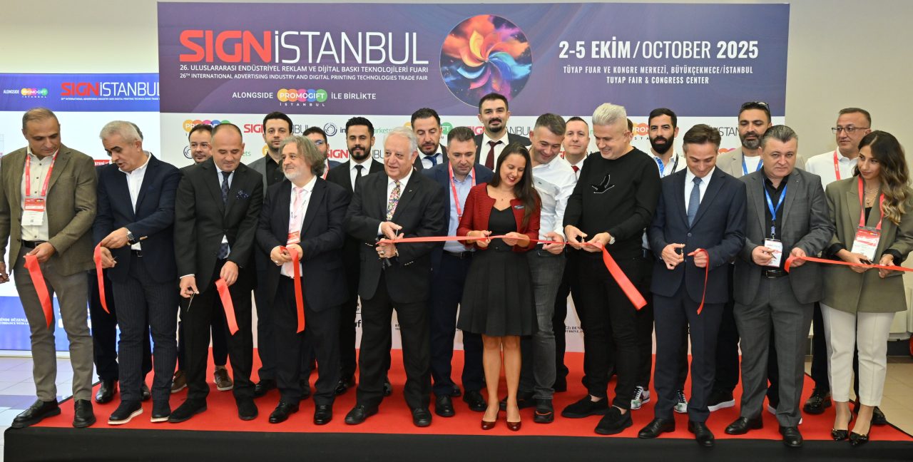 Three SIGN İstanbul team members posing confidently in front of the event backdrop on a red carpet